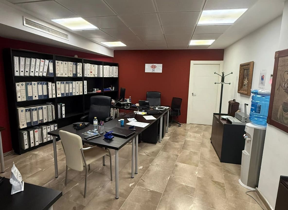 After photo showing the same living room redesigned by AI into a contemporary, minimalist style.